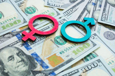 Salary and wage gap concept. Gender symbols and money.
